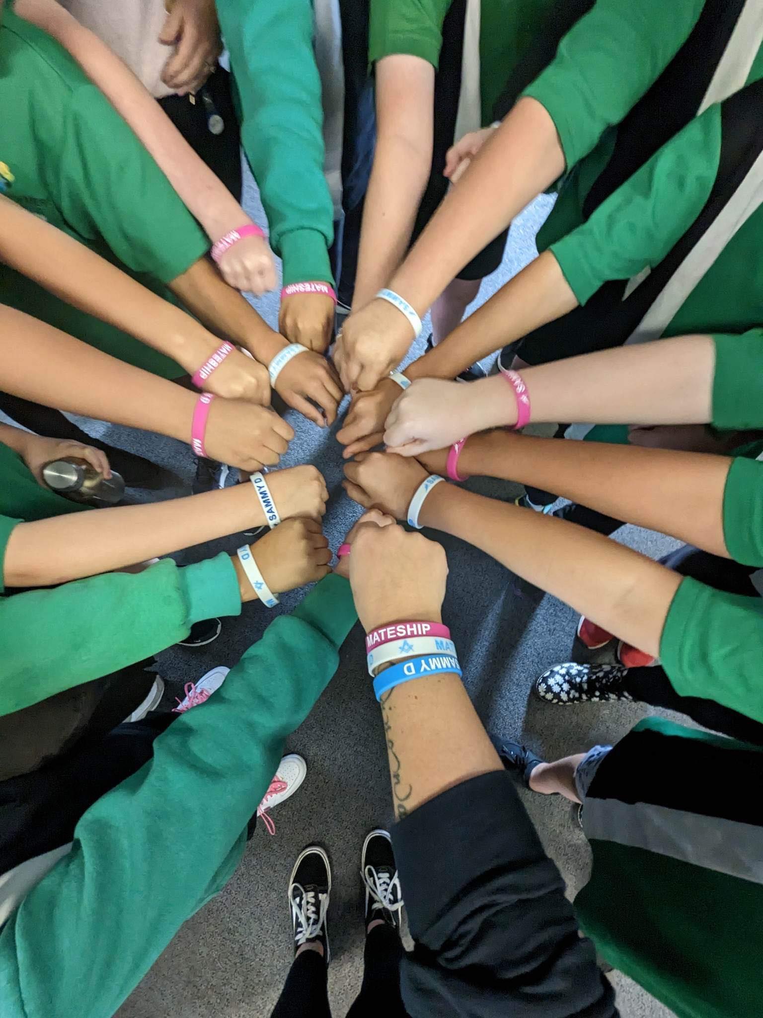Students standing together and wearing Sammy D Foundation wristbands